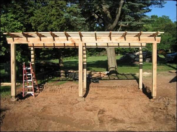 during the installation of rough hewn pergola shade structure