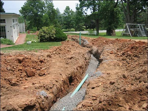 Pipes are laid within the trenches